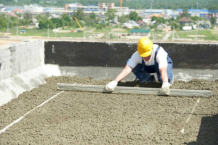 man flattening the sand and gravel