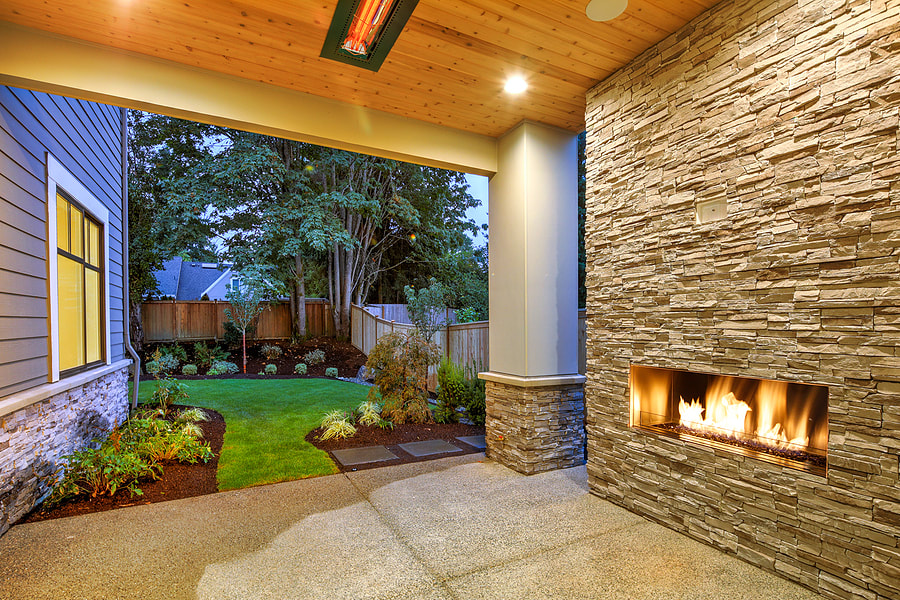 covered and concrete patio with bricked chimney