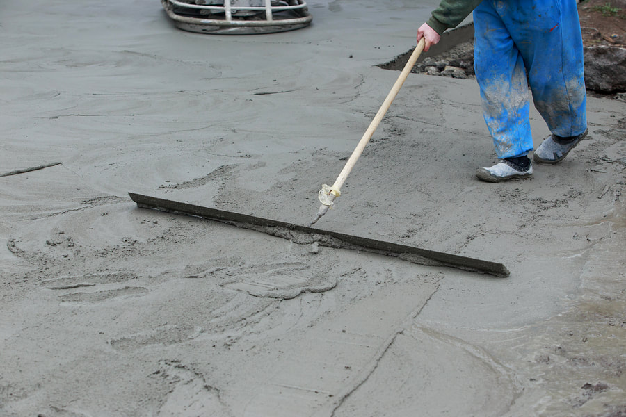 man flattening the concrete cement